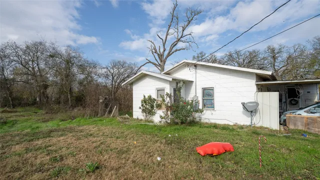 a backyard of a house with table and chairs
