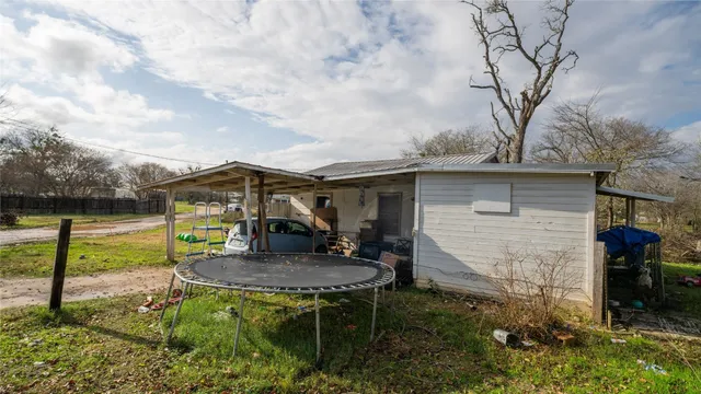 a backyard of a house with table and chairs