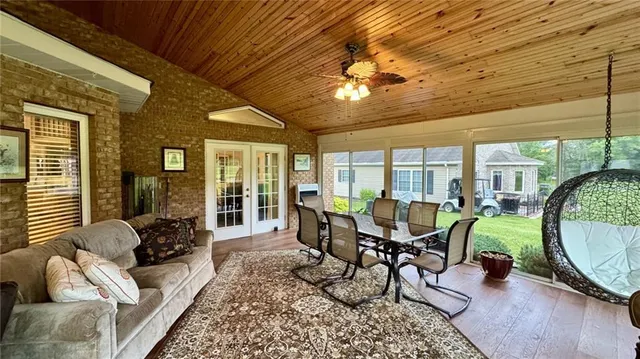a bedroom with a bed and a flat tv screen on dresser