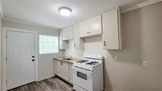 a kitchen with granite countertop a stove and a refrigerator