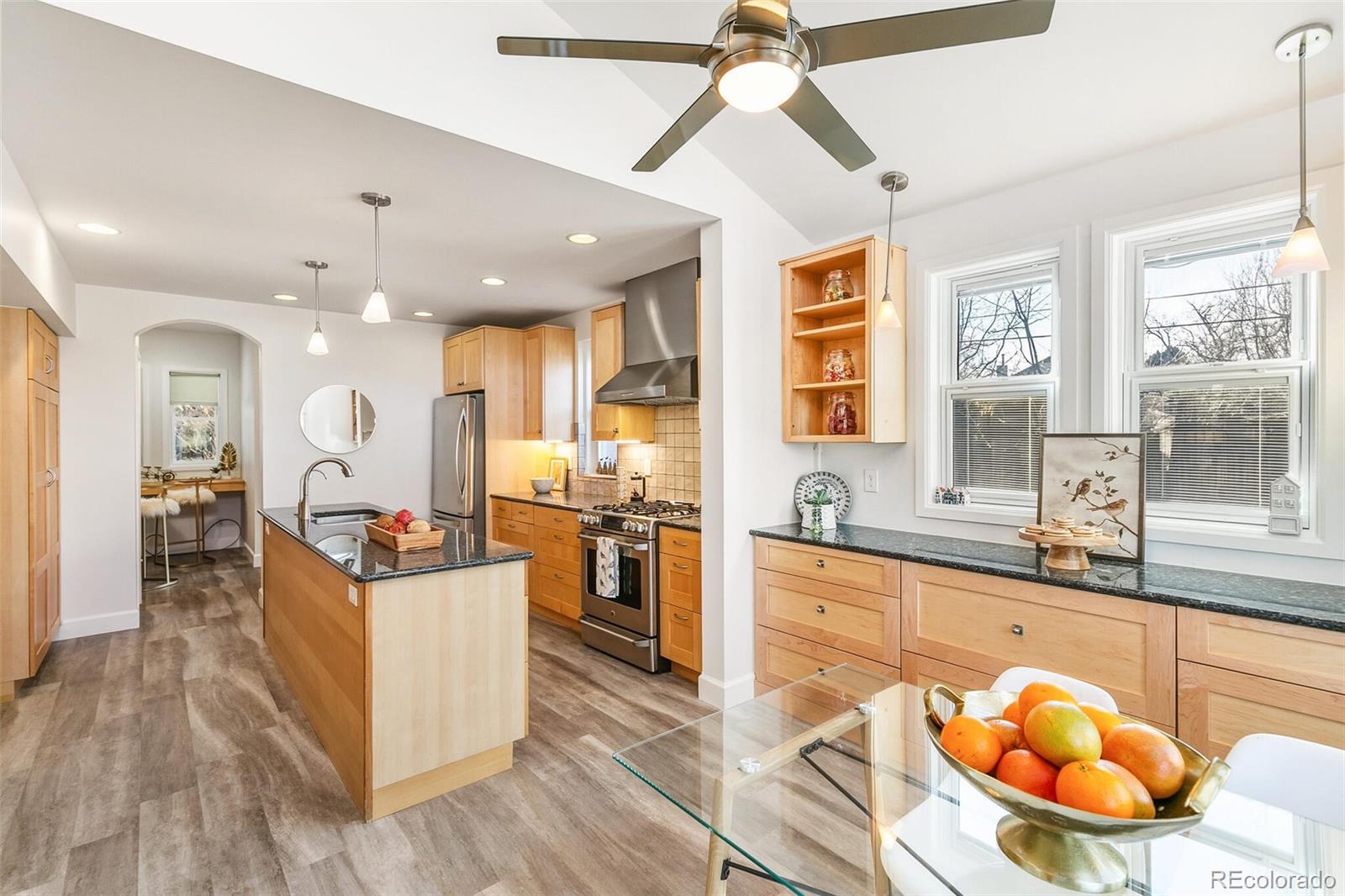 3885 Wolff Street Denver, CO 80212 - Photo 9 of 50 a large kitchen with stainless steel appliances granite countertop a stove and a sink