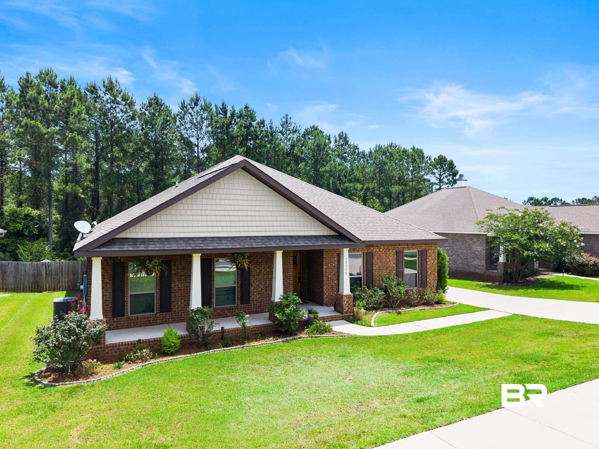 31350 Hoot Owl Road Daphne, AL 36527 - Photo 55 of 94 Brick exterior with decorative shake siding and a covered front porch featuring white columns