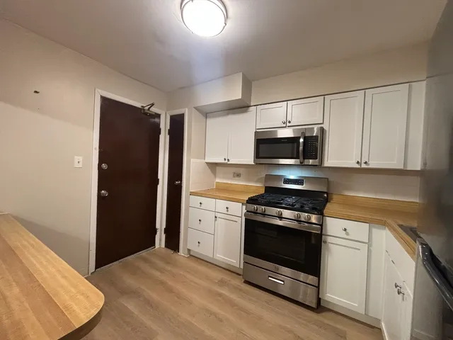 a kitchen with a stove and a microwave