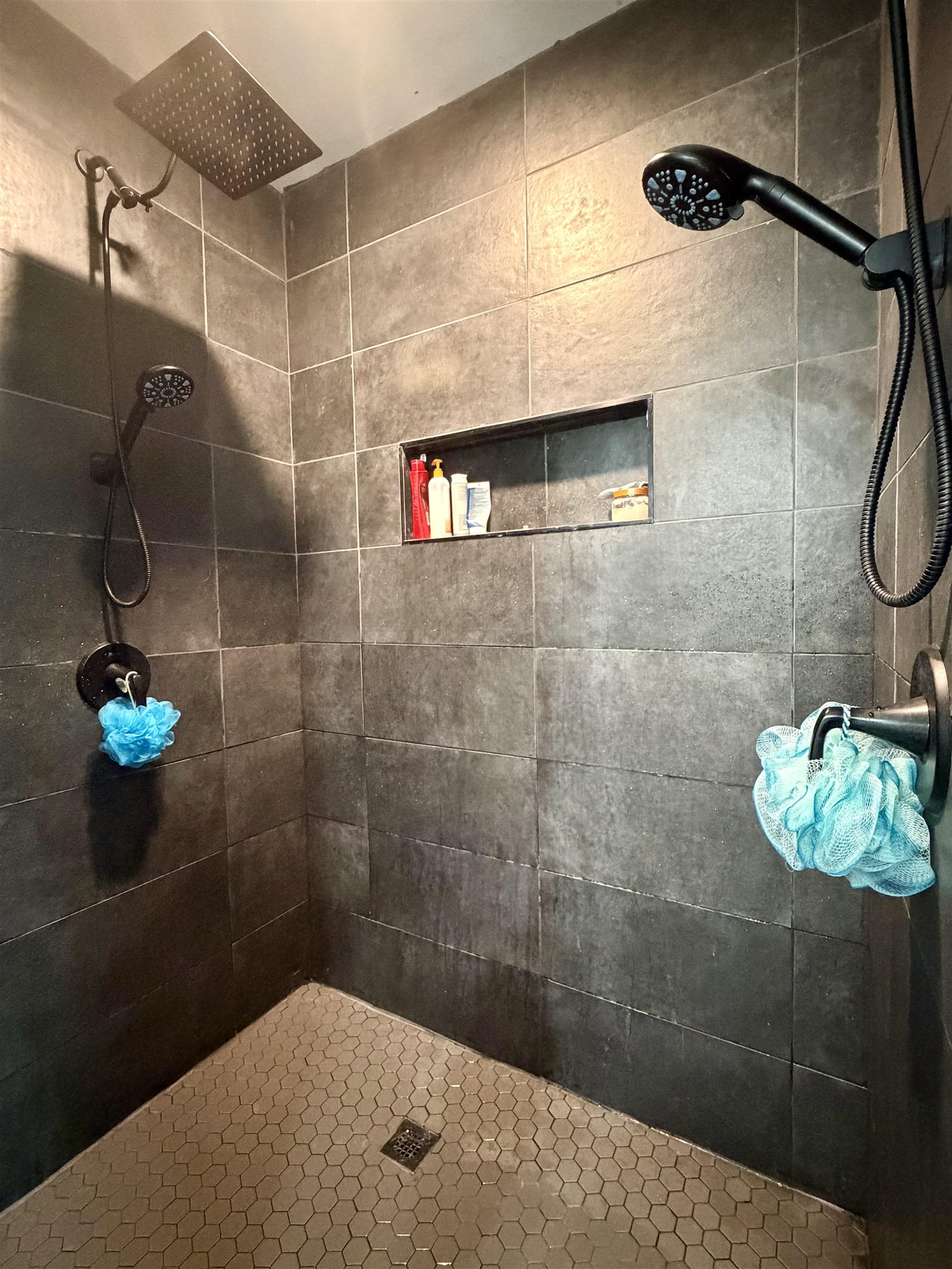 3670 Peavine Road Middleton, TN 38052 - Photo 22 of 36 Modern shower enclosure featuring dark large-format wall tiles and a hexagonal floor tile pattern