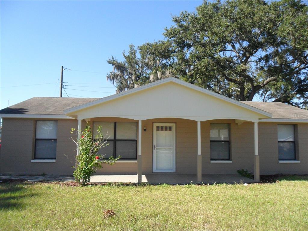 a house that has a tree in front of it