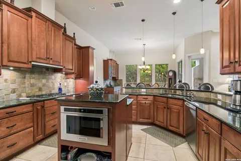 a kitchen with stainless steel appliances a sink stove and cabinets