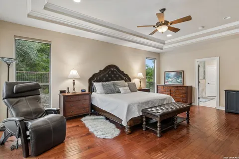a bedroom with a bed a chandelier and a couch