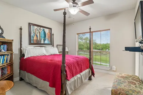 a bedroom with a bed and a large window