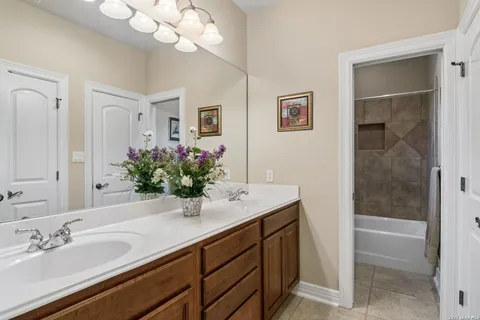 a bathroom with a sink vanity granite and a mirror