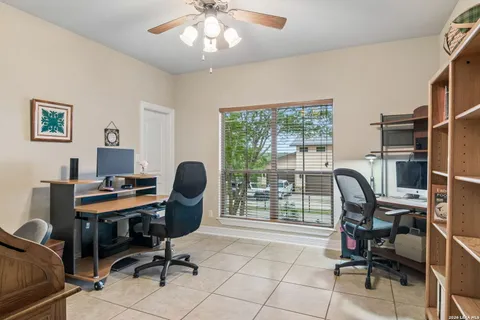 a view of a workspace with furniture and a window