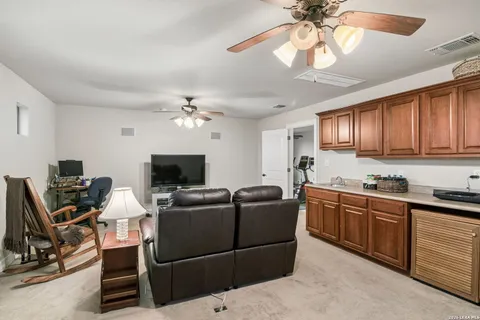 a living room with furniture a dining table and a chandelier