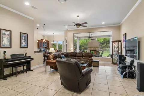 a living room with patio furniture and a flat screen tv