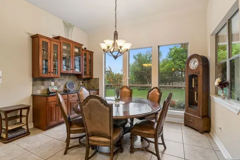 a dining room with furniture a chandelier and a rug
