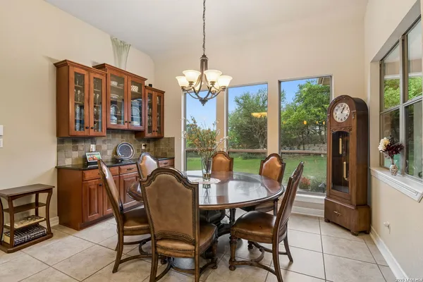 a dining room with furniture a chandelier and a rug