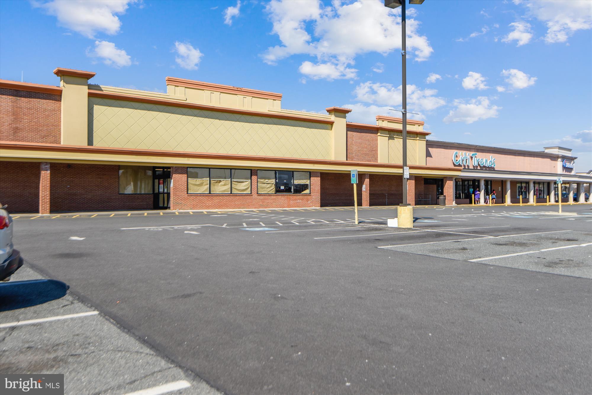292 Colebrook Road Fredericksburg, VA 22405 - Photo 61 of 67 Vacant storefronts under a bright sky.