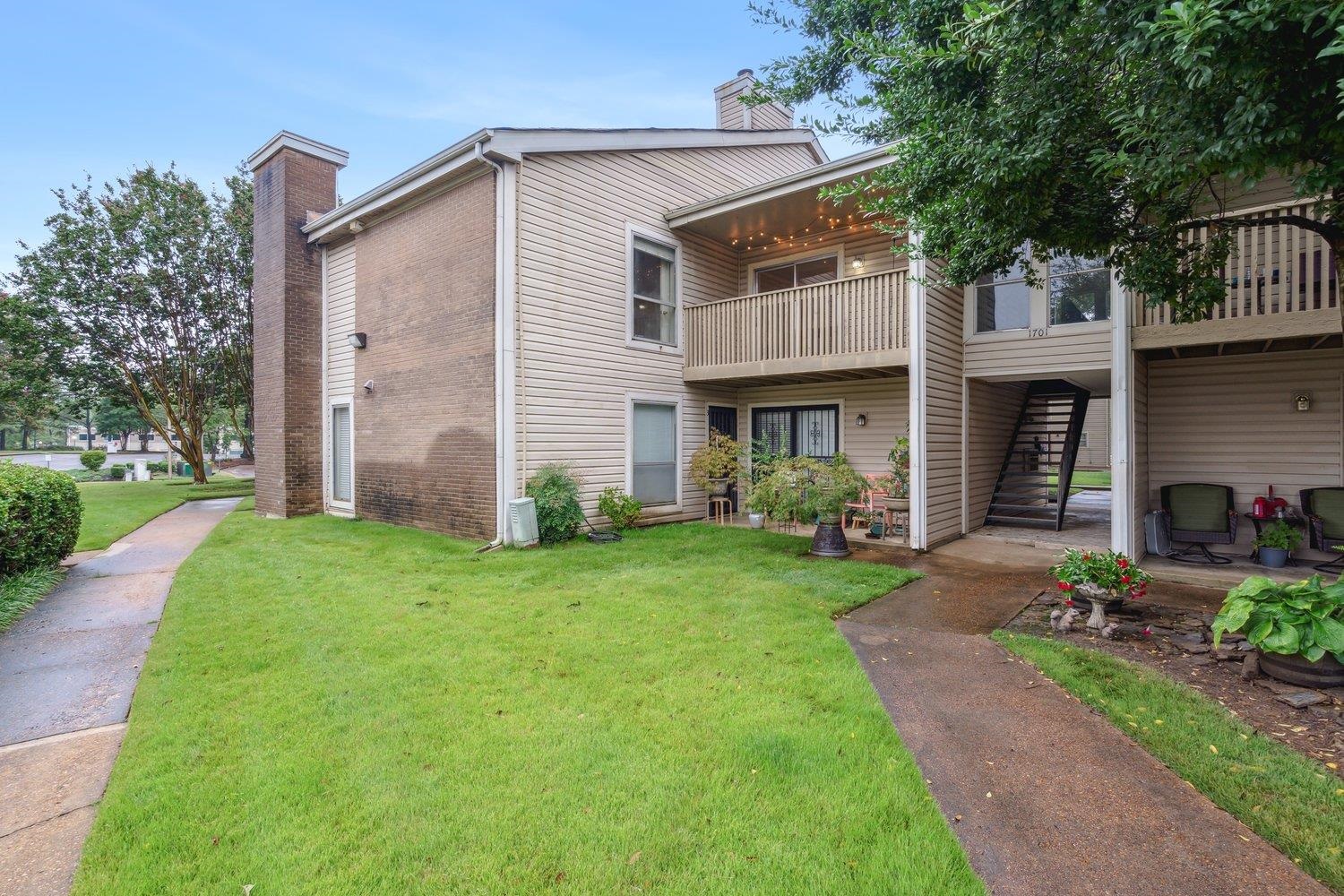 1701 Ridge Oak Place, Unit 4 Memphis, TN 38120 - Photo 1 of 21 a front view of a house with garden
