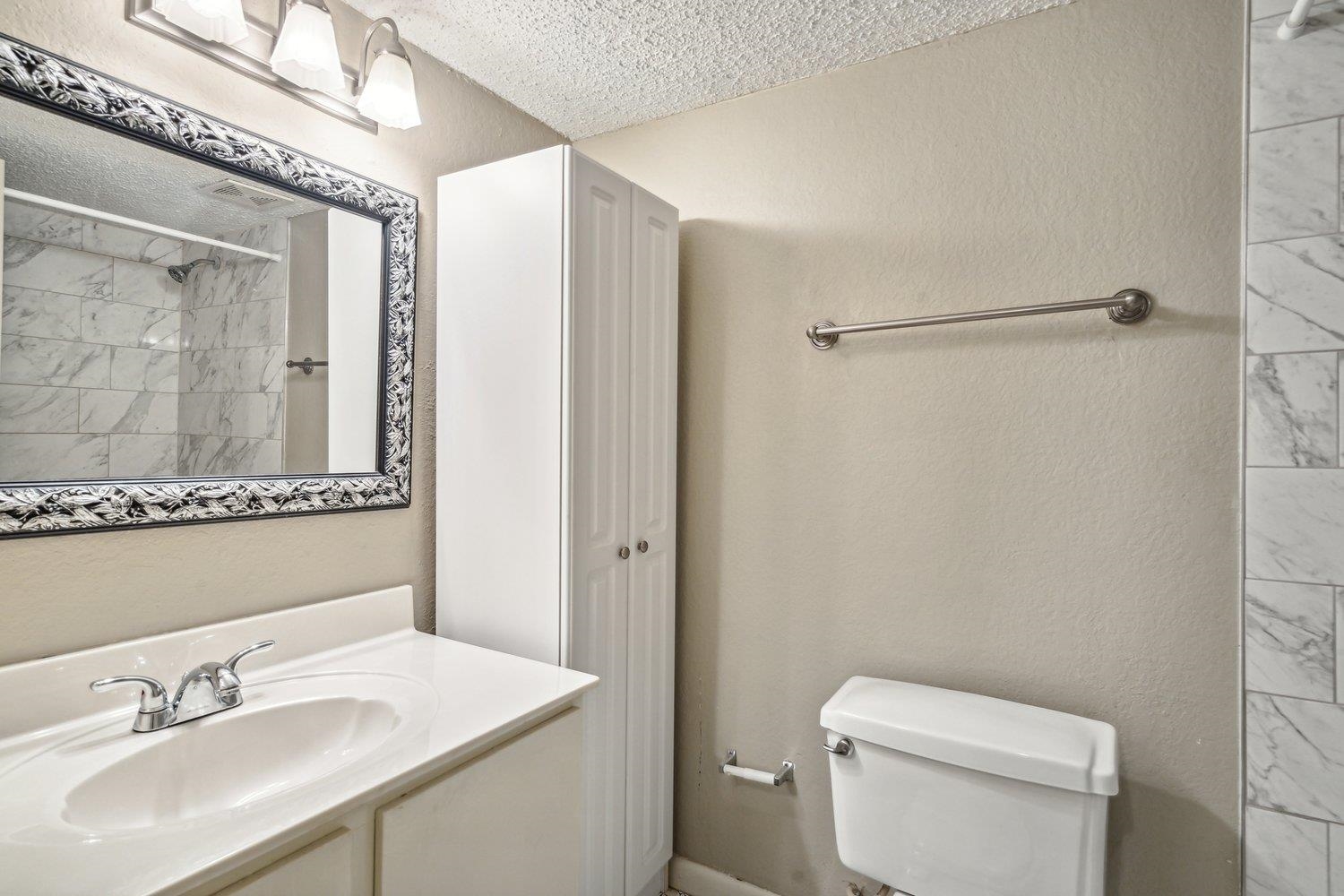 1701 Ridge Oak Place, Unit 4 Memphis, TN 38120 - Photo 15 of 21 a bathroom with a sink toilet and shower