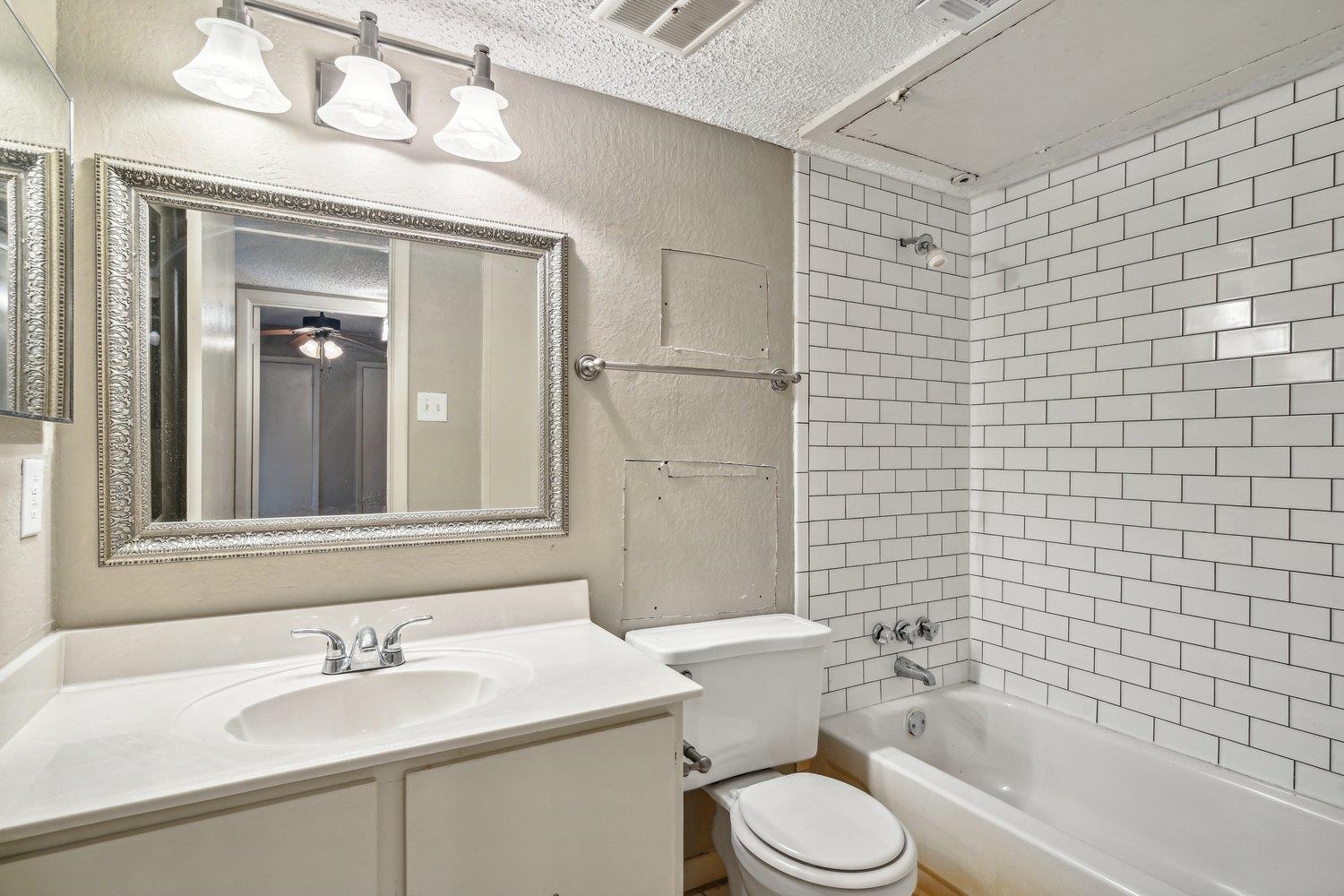 1701 Ridge Oak Place, Unit 4 Memphis, TN 38120 - Photo 17 of 21 a bathroom with a sink toilet and shower