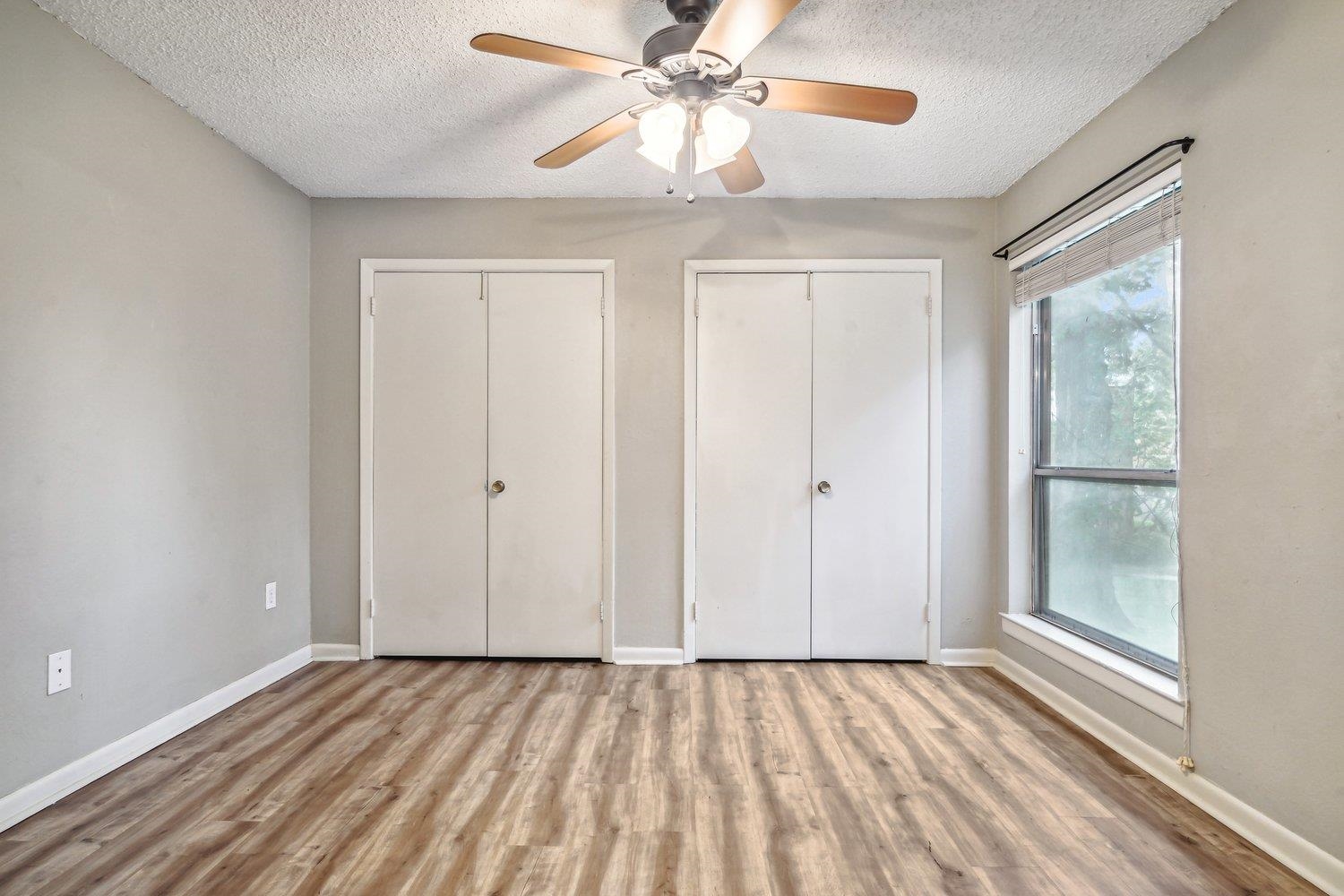 1701 Ridge Oak Place, Unit 4 Memphis, TN 38120 - Photo 18 of 21 a view of an empty room and window chandelier fan
