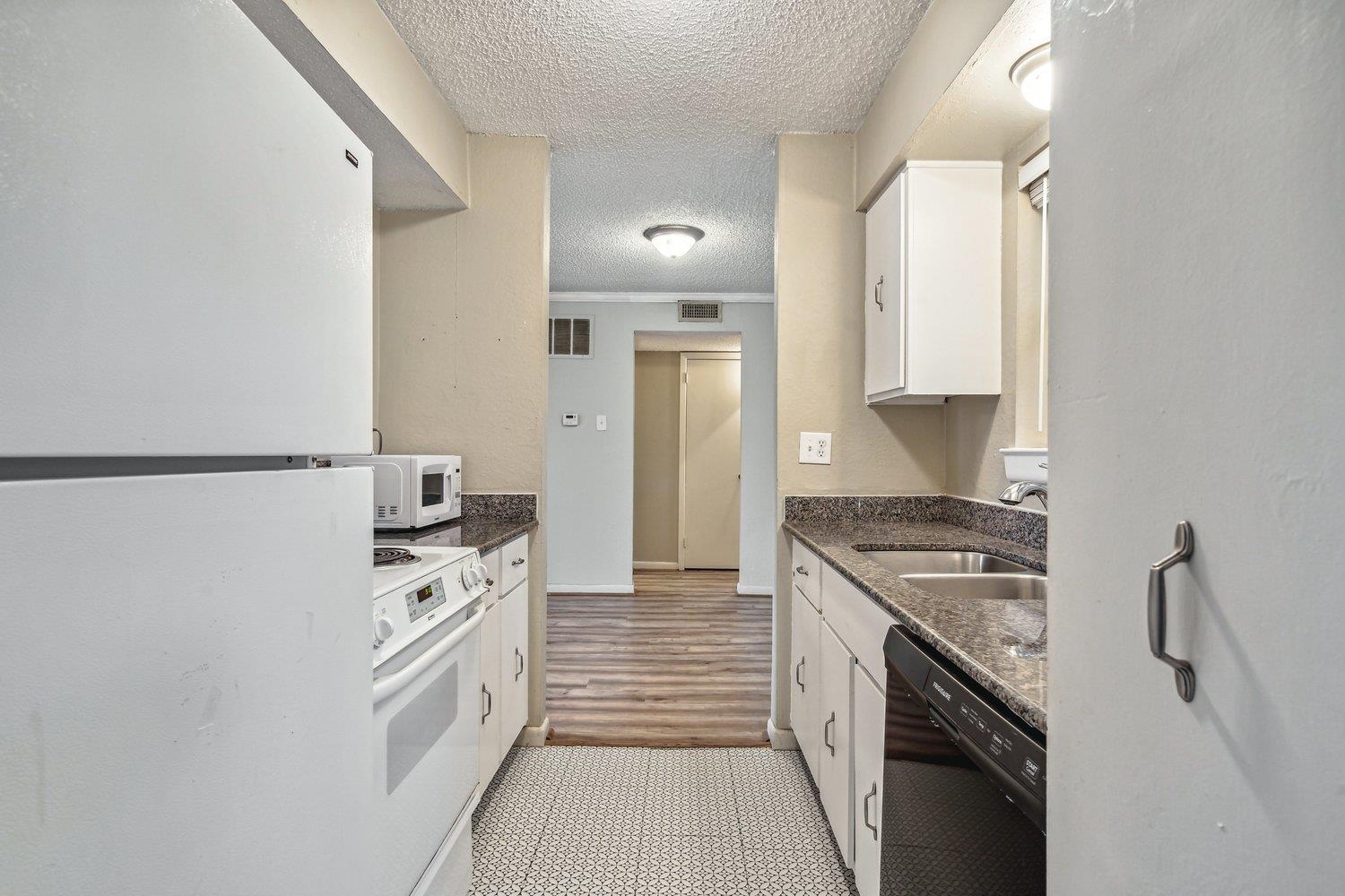 1701 Ridge Oak Place, Unit 4 Memphis, TN 38120 - Photo 3 of 21 a kitchen with stainless steel appliances granite countertop a stove and a refrigerator