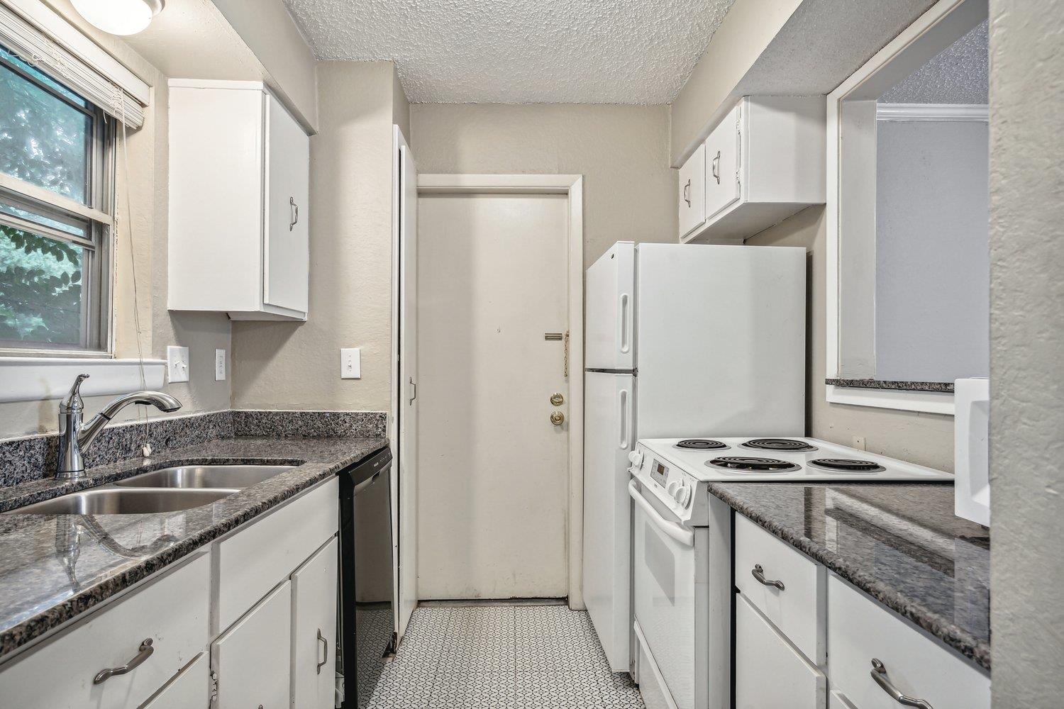 1701 Ridge Oak Place, Unit 4 Memphis, TN 38120 - Photo 4 of 21 a kitchen with stainless steel appliances granite countertop a sink stove and refrigerator