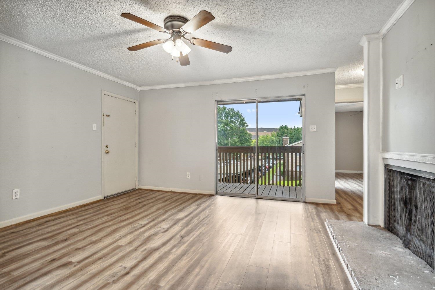1701 Ridge Oak Place, Unit 4 Memphis, TN 38120 - Photo 10 of 21 wooden floor in an empty room with a window