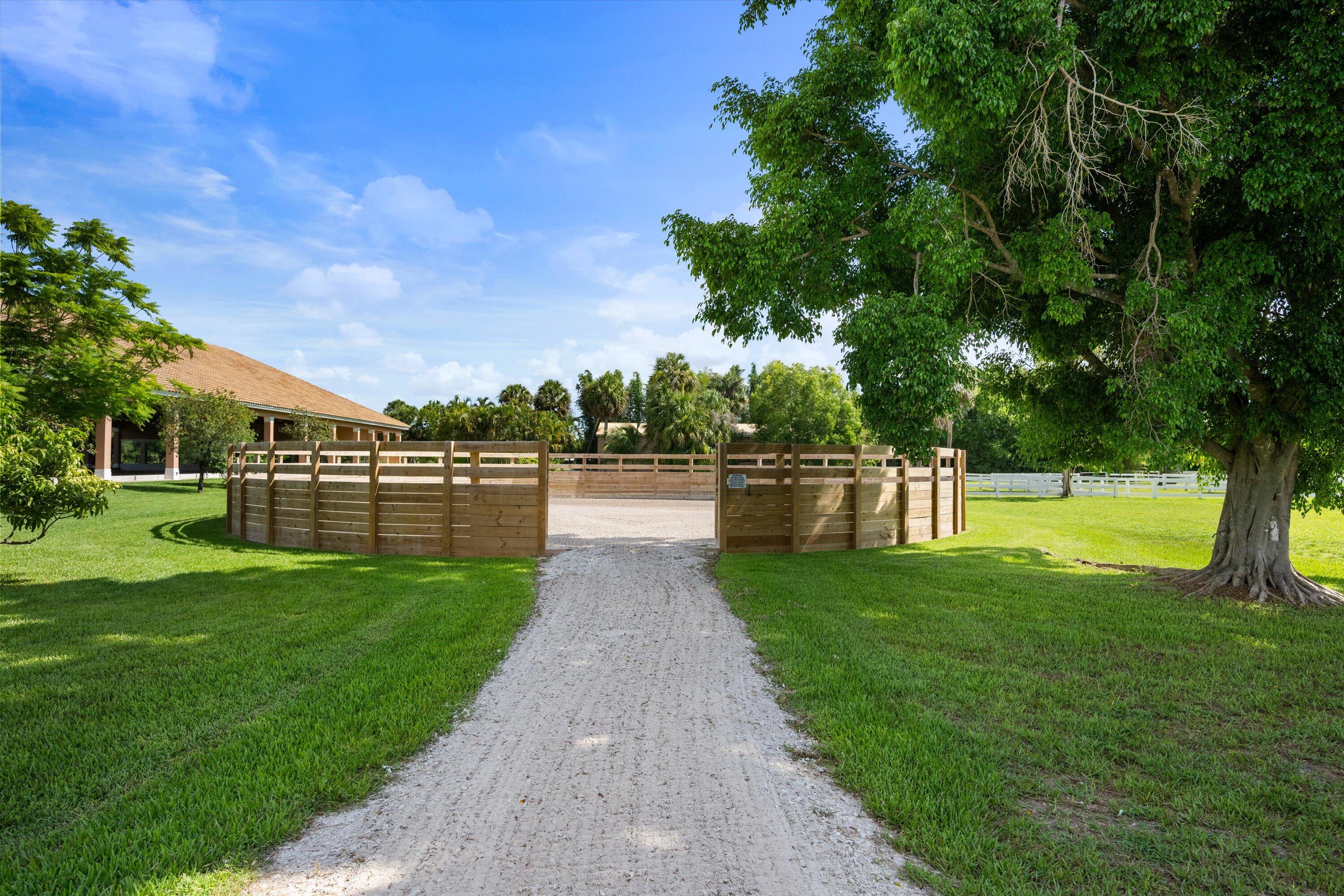 3287 Grande Road Loxahatchee, FL 33470 - Photo 107 of 126 a view of a swimming pool with a garden