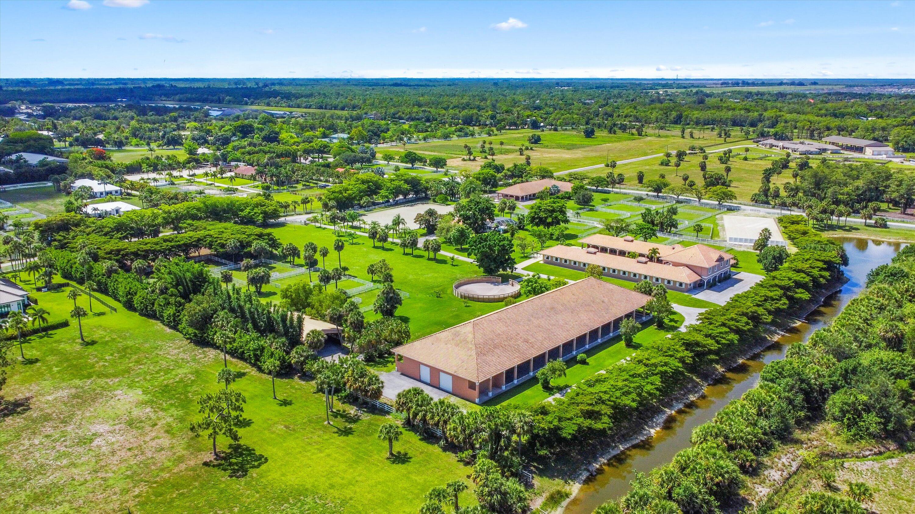 3287 Grande Road Loxahatchee, FL 33470 - Photo 120 of 126 an aerial view of residential houses with outdoor space and trees
