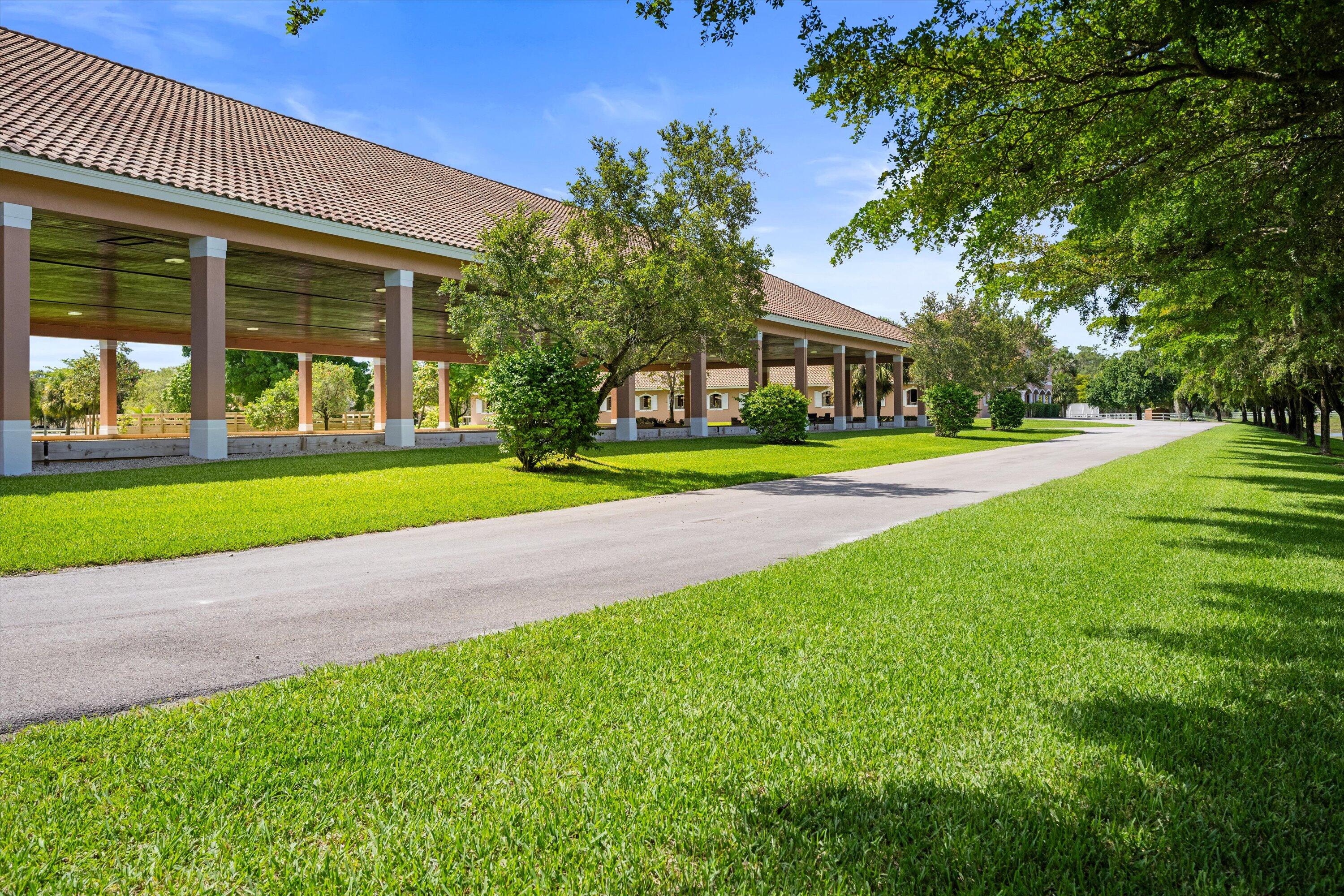 3287 Grande Road Loxahatchee, FL 33470 - Photo 39 of 126 a view of a house next to a yard and large trees