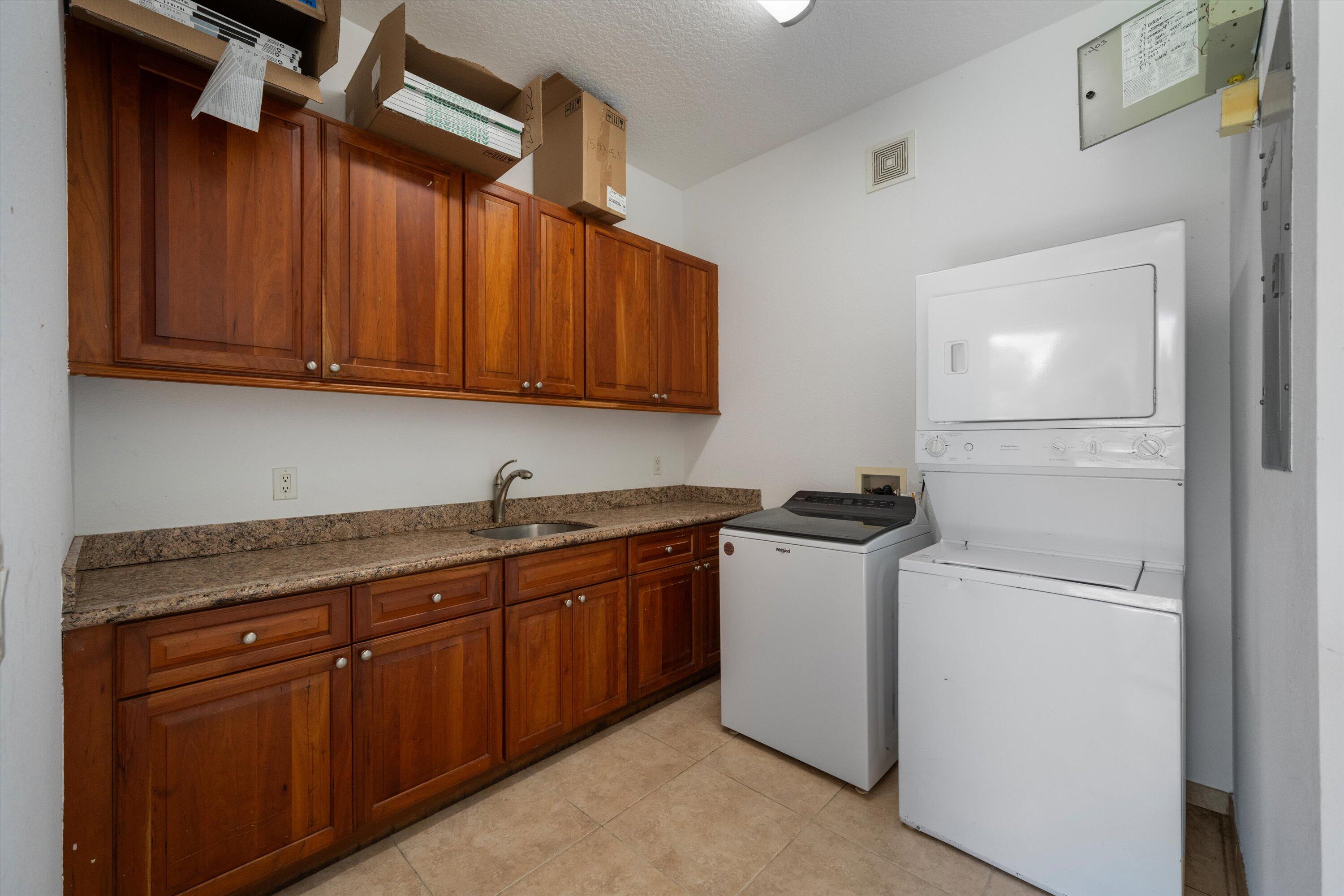 3287 Grande Road Loxahatchee, FL 33470 - Photo 47 of 126 a kitchen with stainless steel appliances granite countertop a refrigerator and a sink