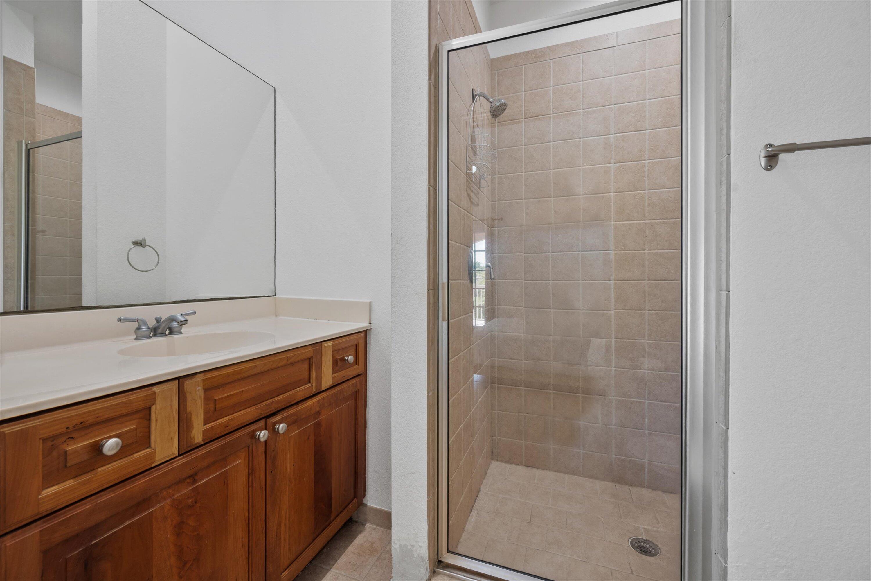 3287 Grande Road Loxahatchee, FL 33470 - Photo 69 of 126 a bathroom with a shower sink and mirror