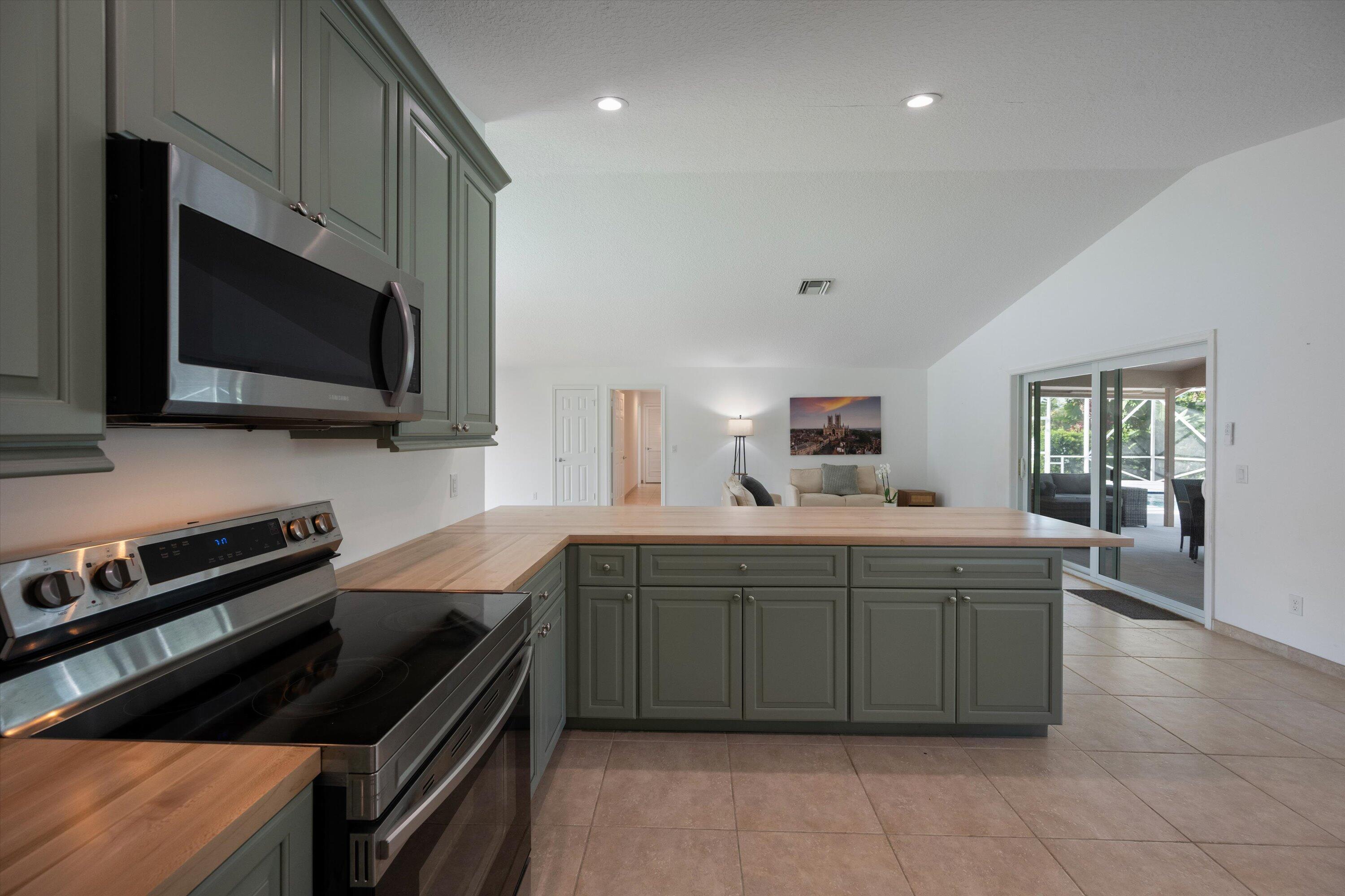3287 Grande Road Loxahatchee, FL 33470 - Photo 79 of 126 a kitchen with a stove and a microwave