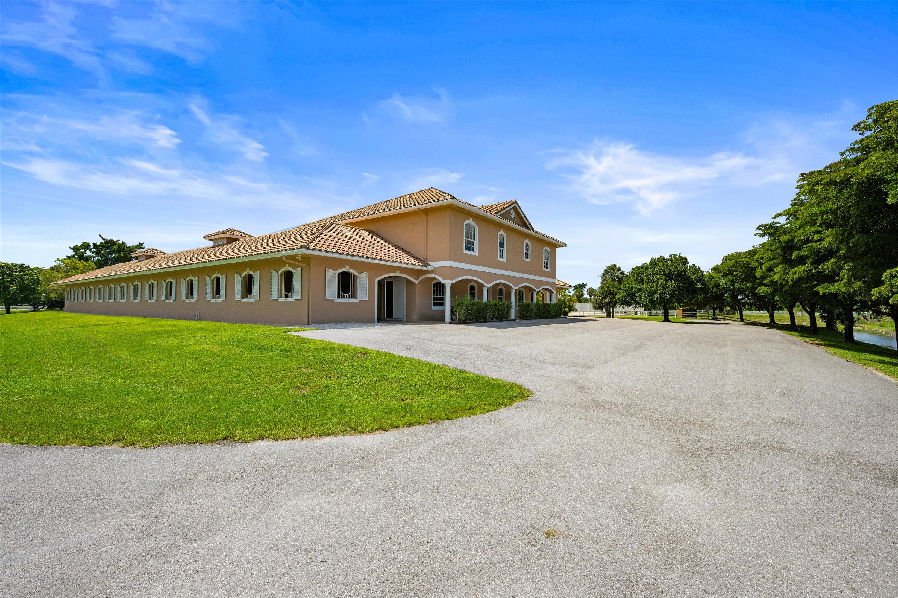 3287 Grande Road Loxahatchee, FL 33470 - Photo 8 of 126 a front view of a house with a yard