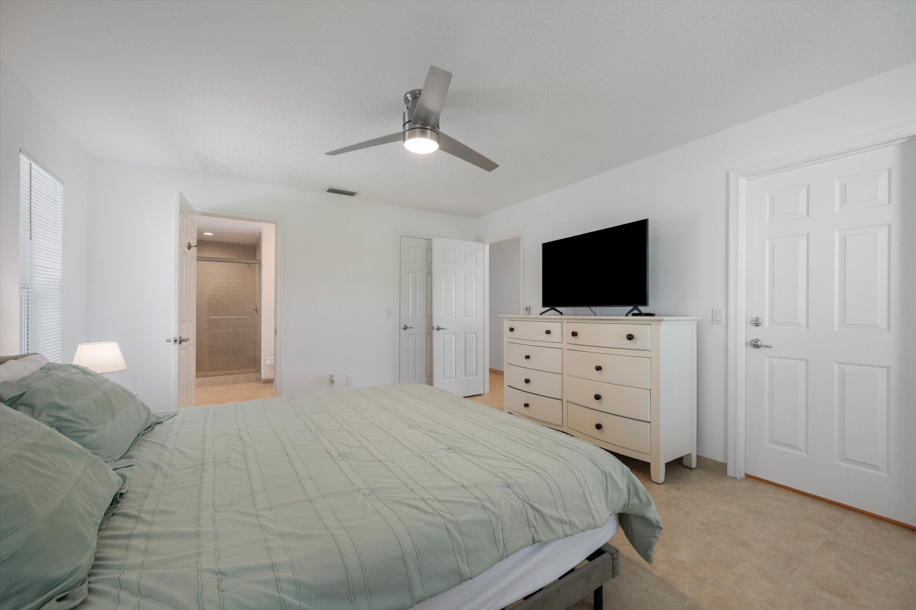 3287 Grande Road Loxahatchee, FL 33470 - Photo 88 of 126 a bedroom with a bed and a flat screen tv