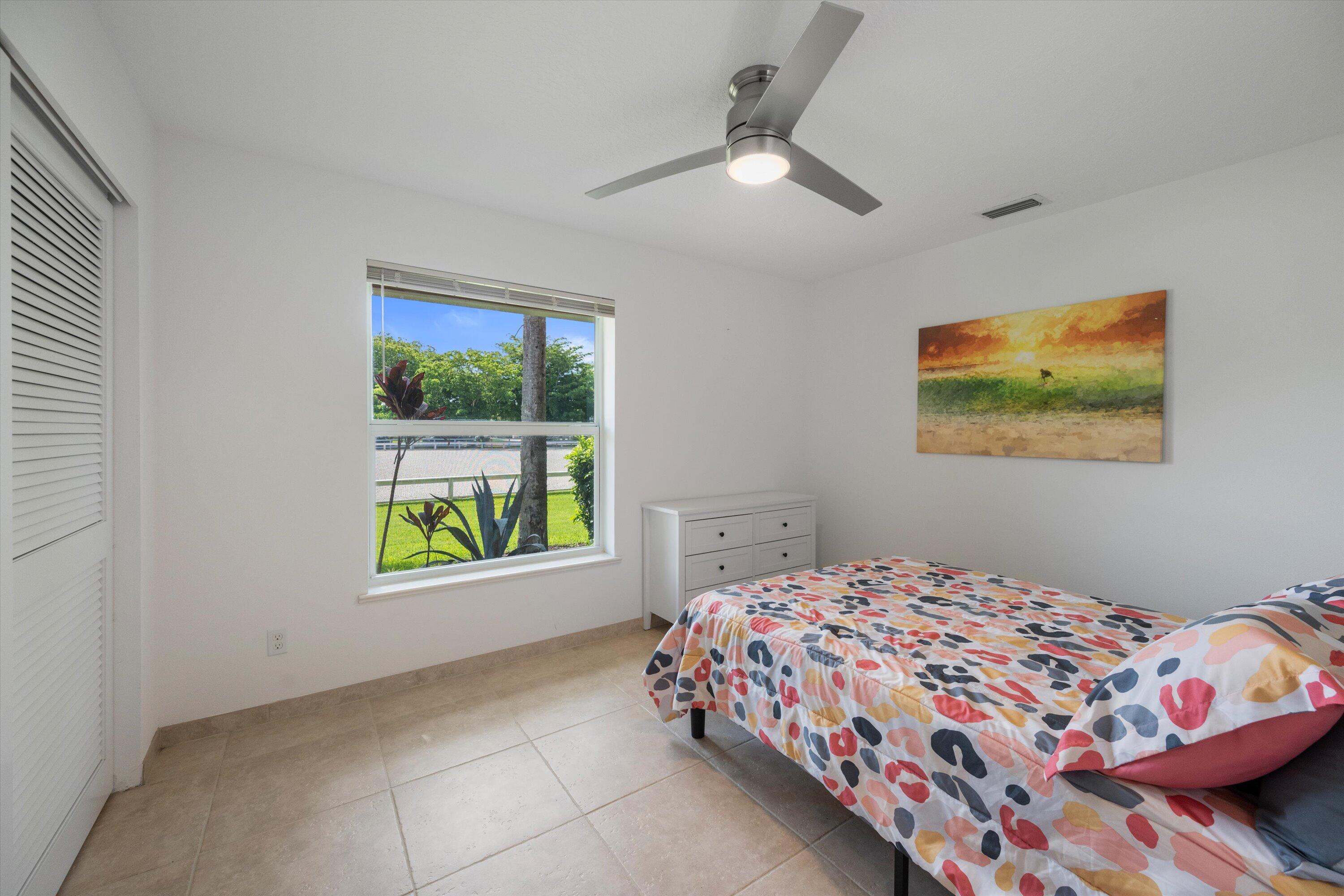 3287 Grande Road Loxahatchee, FL 33470 - Photo 90 of 126 a bedroom with a bed and a window