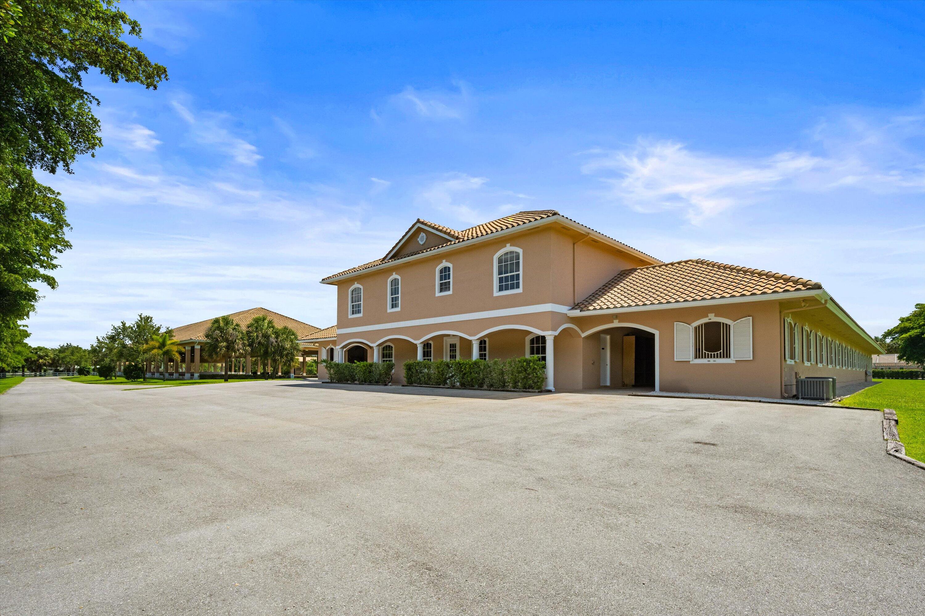 3287 Grande Road Loxahatchee, FL 33470 - Photo 10 of 126 a front view of a house with a yard