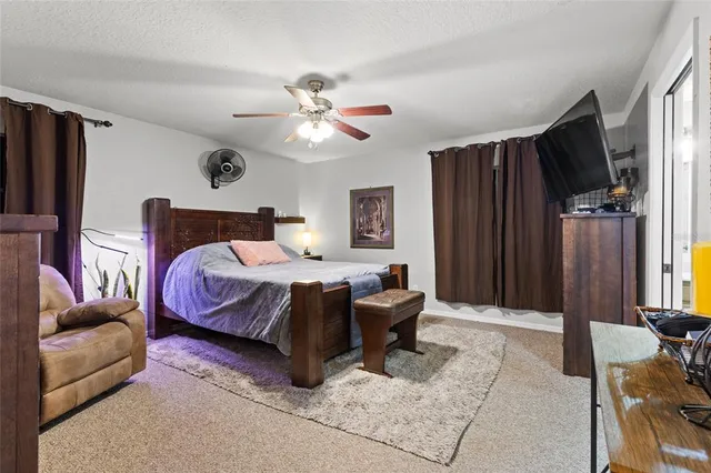 a bedroom with a bed couch and a window