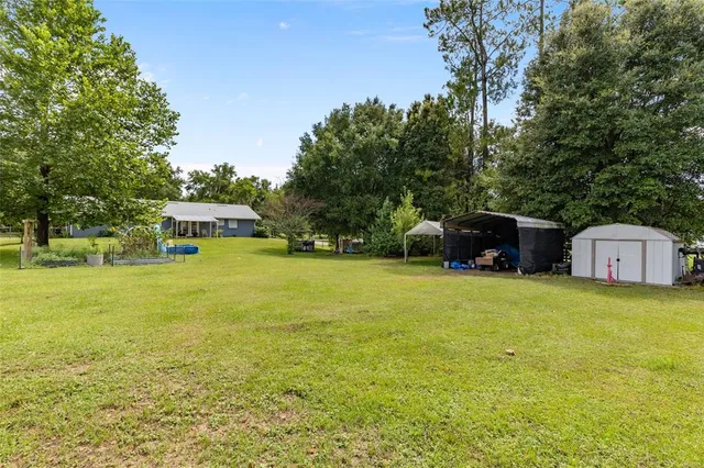 a tall yellow building in the middle of a field