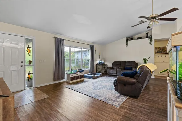 a living room with furniture window and wooden floor