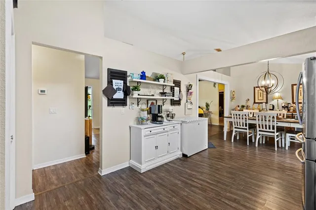 a kitchen with white cabinets and wooden floor