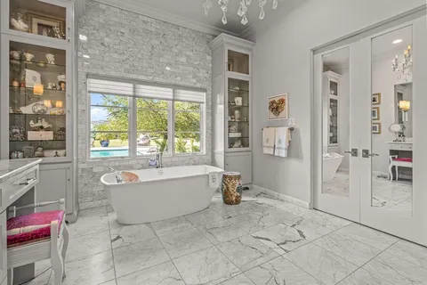 a spacious bathroom with shower bathtub and window