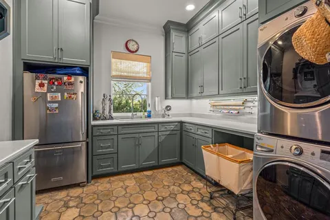 a utility room with sink dryer and washer