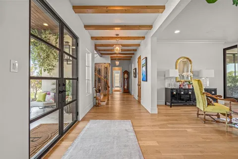 a hallway with wooden floor and furniture