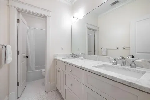 a bathroom with a double vanity sink and mirror