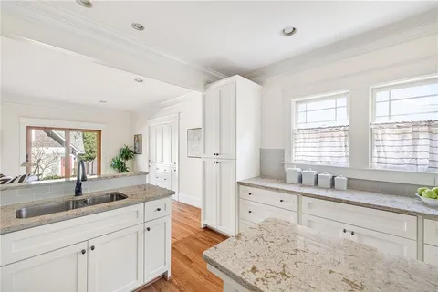 a spacious bathroom with double vanity and a large mirror