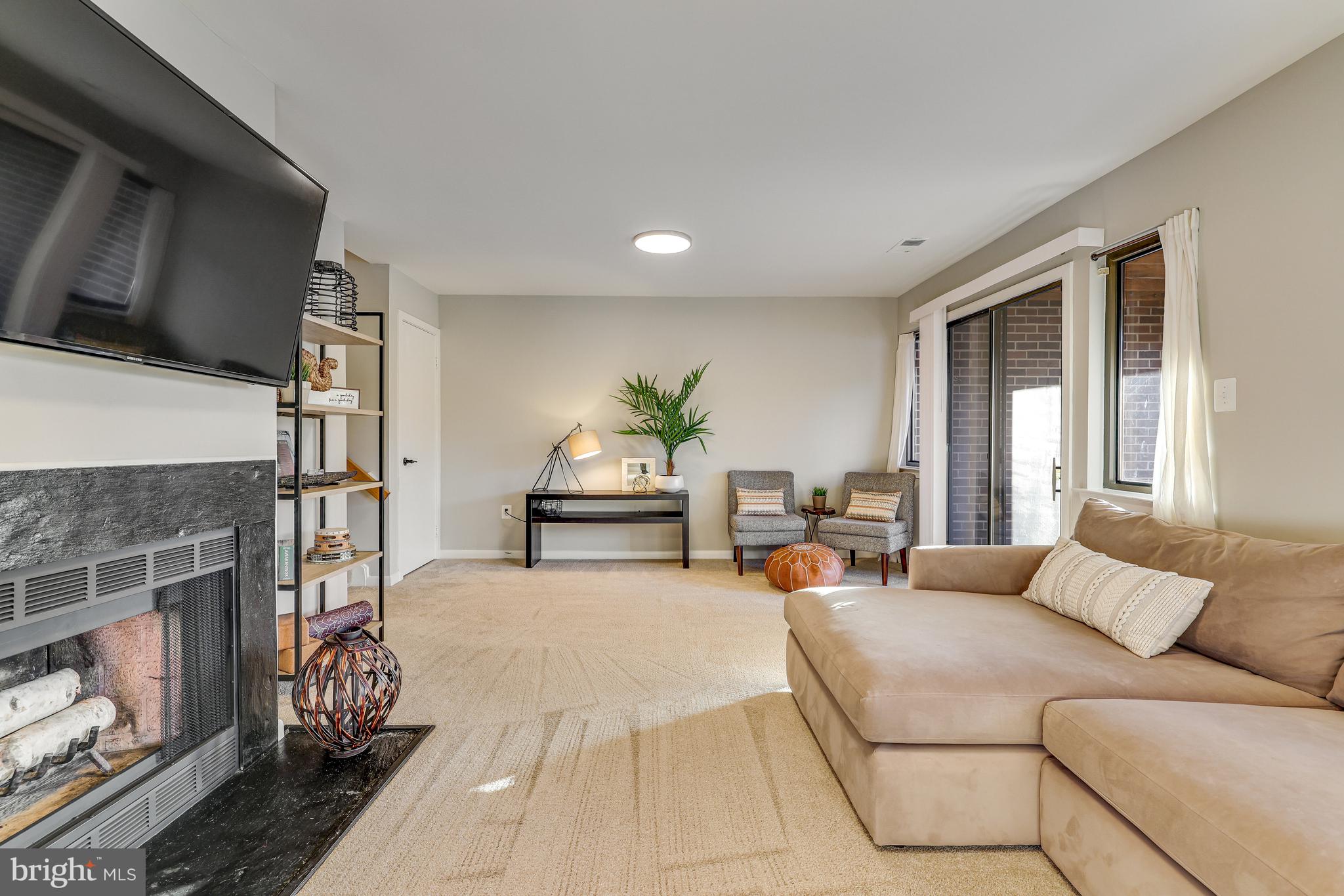 11010 Thrush Ridge Road Reston, VA 20191 - Photo 46 of 87 a living room with furniture flat screen tv and a fireplace