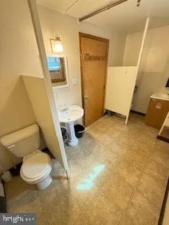 a white toilet sitting next to a bathroom sink