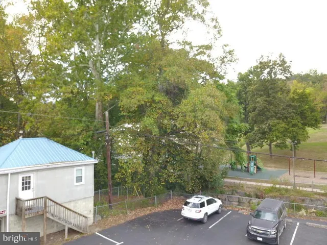 a blue swimming pool with a yard from inside the house