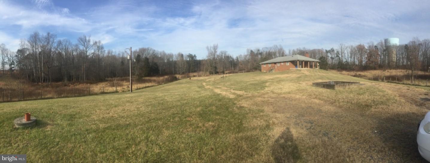 a view of a field with trees in the background