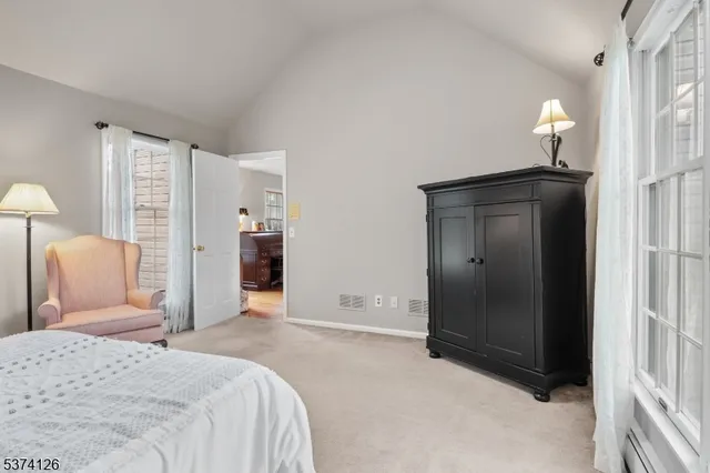 a bedroom with a bed and a lamp